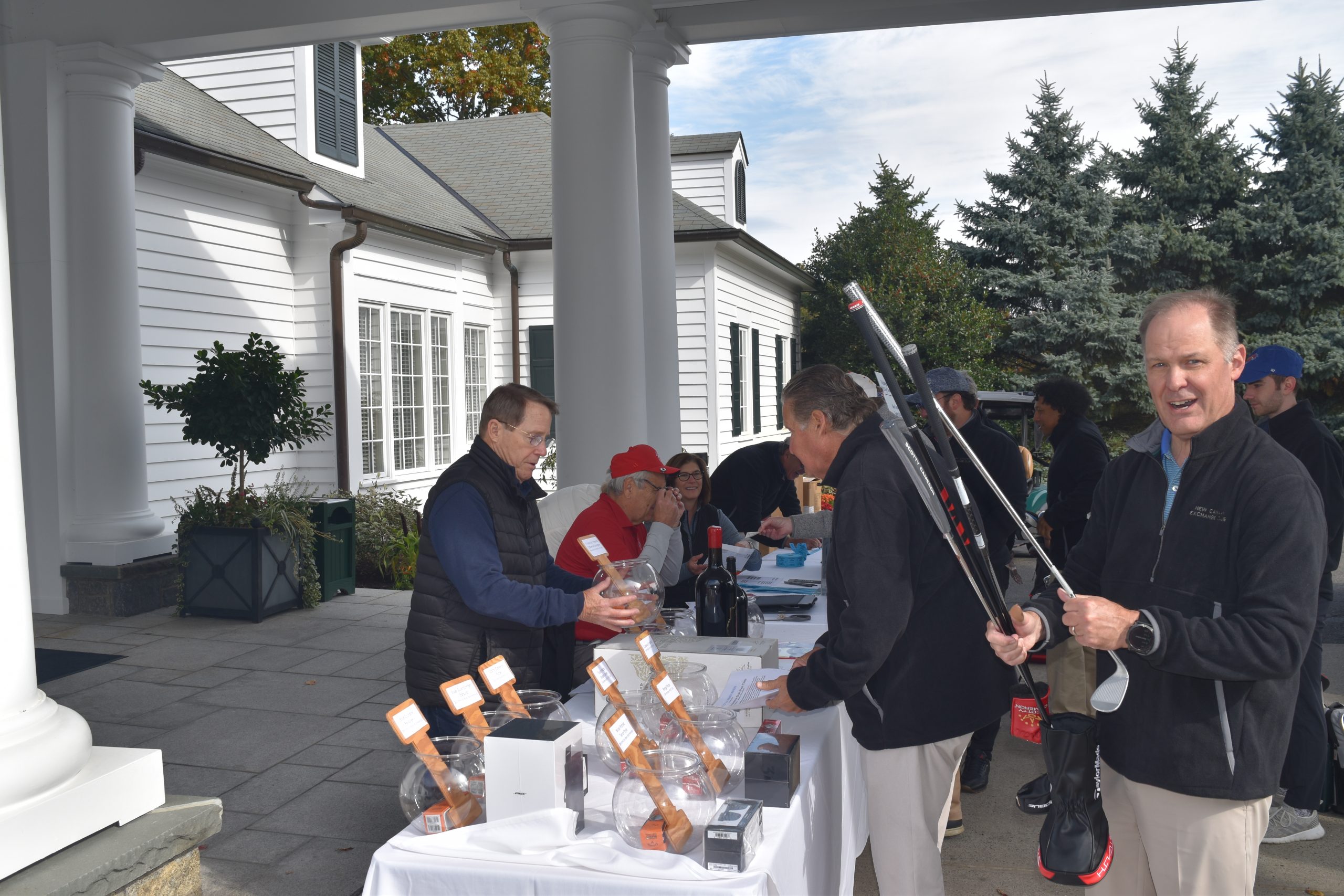2022 Exchange Club Golf outing at Woodway Country Club. Left to right -- Joel Pelzner. Mark Hahn, Cathleen Abbott (at desk), Standing Bill Acker and Mike Abbott (holding clubs)
